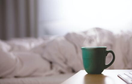 Hot drink next to a bed